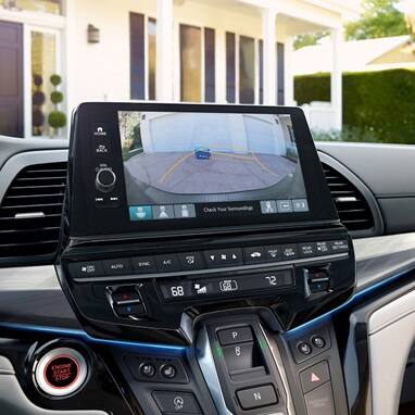 2027 Honda Odyssey Elite infotainment screen showing the rearview camera and climate controls (Minivan).